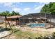 This backyard offers a screened-in pool and plenty of space for recreation at 690 S Lakemont Ave, Winter Park, FL 32792