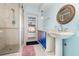 Bathroom with a step-in shower and pedestal sink with access to outdoor pool area at 690 S Lakemont Ave, Winter Park, FL 32792
