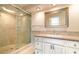 Bathroom featuring a walk-in glass shower, elegant vanity, and neutral tones at 690 S Lakemont Ave, Winter Park, FL 32792