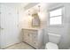 Bathroom with a toilet, a vanity sink, and a window, providing a bright and clean space at 690 S Lakemont Ave, Winter Park, FL 32792
