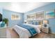 Inviting bedroom with blue walls, white furniture, and bright natural light from the two large windows at 690 S Lakemont Ave, Winter Park, FL 32792