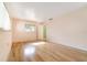 Bright bedroom featuring hardwood flooring, white walls, and natural light from a window at 690 S Lakemont Ave, Winter Park, FL 32792
