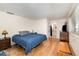 This bedroom features wood floors, a blue comforter, closet and an adjacent bathroom at 690 S Lakemont Ave, Winter Park, FL 32792