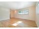 Bright bedroom with wood flooring and a large window offering natural light at 690 S Lakemont Ave, Winter Park, FL 32792
