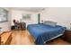 Bedroom boasts natural light, a comfy blue comforter, a wooden dresser, and a home office setup at 690 S Lakemont Ave, Winter Park, FL 32792