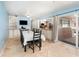 Bright dining room adjacent to the kitchen featuring tile floors, a dining table, and ample natural light at 690 S Lakemont Ave, Winter Park, FL 32792