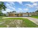 Charming ranch style home with stone accents, solar panels and a well manicured circular driveway at 690 S Lakemont Ave, Winter Park, FL 32792