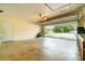 Spacious garage with an automatic door opener, large work area, and access to the exterior at 690 S Lakemont Ave, Winter Park, FL 32792