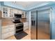 Well-lit kitchen with stainless steel appliances, light cabinets and granite countertops at 690 S Lakemont Ave, Winter Park, FL 32792