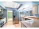 Well-lit kitchen features granite countertops, stainless steel appliances, and ample cabinet space at 690 S Lakemont Ave, Winter Park, FL 32792