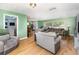 Bright living room boasting hardwood floors, a large window, neutral furniture, and easy access to other rooms at 690 S Lakemont Ave, Winter Park, FL 32792