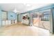 Bright living room with tile flooring, built-in cabinets, and sliding glass doors to the outside patio at 690 S Lakemont Ave, Winter Park, FL 32792