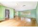 Bright living room boasts hardwood floors, a large window, and an open entryway to the kitchen at 690 S Lakemont Ave, Winter Park, FL 32792