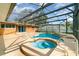 A sparkling in-ground pool features a screened enclosure, a spa, and lots of room for activities around the pool at 690 S Lakemont Ave, Winter Park, FL 32792