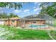 Backyard features a screened-in pool, hot tub, and a swing set at 690 S Lakemont Ave, Winter Park, FL 32792