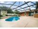 A beautiful pool with a spa, lush landscaping, and a screened enclosure offering a private outdoor oasis at 690 S Lakemont Ave, Winter Park, FL 32792