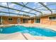 An inviting in-ground pool with a screened enclosure and ample patio space, great for relaxation and entertainment at 690 S Lakemont Ave, Winter Park, FL 32792