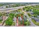 Aerial view of a home near a highway, surrounded by lush trees and well-kept lawns at 712 Baffie Ave, Winter Park, FL 32789