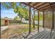 Covered porch looks out onto fenced backyard with tree at 712 Baffie Ave, Winter Park, FL 32789