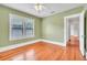 Empty bedroom features hardwood floors, a ceiling fan, a window, and a door to another room at 712 Baffie Ave, Winter Park, FL 32789