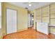 Bedroom featuring hardwood floors, built-in shelves and cabinet, and closet at 712 Baffie Ave, Winter Park, FL 32789