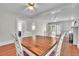 Dining room featuring hardwood floors, ceiling fan, access to a porch via French doors and fireplace at 712 Baffie Ave, Winter Park, FL 32789