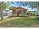Charming home with an inviting red door, light green paint, and well-maintained front yard at 712 Baffie Ave, Winter Park, FL 32789