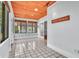 Bright sunroom featuring tiled floors, a wood ceiling, and multiple windows for natural light at 712 Baffie Ave, Winter Park, FL 32789