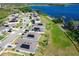 Beautiful aerial view of neighborhood homes with solar panels next to a serene lake at 744 Simone Ct, Haines City, FL 33844