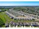 Scenic aerial view of a residential neighborhood surrounded by lush greenery, lakes and a distant cityscape at 744 Simone Ct, Haines City, FL 33844