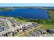 Gorgeous aerial view of a lakeside neighborhood with homes adorned with solar panels for sustainable living at 744 Simone Ct, Haines City, FL 33844