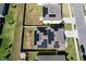 Aerial view showcasing houses with solar panels in a community at 744 Simone Ct, Haines City, FL 33844