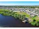 Gorgeous aerial view of homes with solar panels by a lake and dock at 744 Simone Ct, Haines City, FL 33844