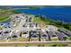 Scenic aerial view highlighting a neighborhood with solar-equipped homes and a stunning waterfront backdrop at 744 Simone Ct, Haines City, FL 33844