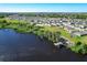 Beautiful aerial view of waterfront community with lush greenery and a private dock on the lake at 744 Simone Ct, Haines City, FL 33844