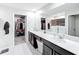 Bathroom boasts a double sink vanity, large mirror and walk-in closet at 744 Simone Ct, Haines City, FL 33844