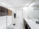Well-lit bathroom featuring a double sink vanity, large mirror and tiled floors at 744 Simone Ct, Haines City, FL 33844