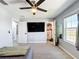 This gray-walled bedroom includes a ceiling fan, mounted TV and large closet at 744 Simone Ct, Haines City, FL 33844