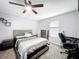 Bedroom with neutral walls, ceiling fan, gray carpet, and furnishings at 744 Simone Ct, Haines City, FL 33844