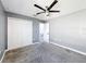 This cozy bedroom features a ceiling fan, soft gray walls and a spacious closet at 744 Simone Ct, Haines City, FL 33844