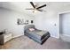 This cozy bedroom has a gray accent wall and matching gray carpet at 744 Simone Ct, Haines City, FL 33844