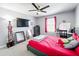 Brightly lit bedroom includes a ceiling fan, TV, carpet, and a vanity at 744 Simone Ct, Haines City, FL 33844