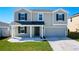Charming two-story home featuring a landscaped front yard, attached garage, and welcoming covered front porch at 744 Simone Ct, Haines City, FL 33844