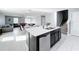 Kitchen island with stainless steel dishwasher and sink overlooking the living areas at 744 Simone Ct, Haines City, FL 33844