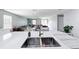 Modern kitchen with stainless steel appliances and an island with a sink at 744 Simone Ct, Haines City, FL 33844