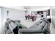 Expansive living area with a pool table, kitchen, and large sectional sofa, perfect for entertaining at 744 Simone Ct, Haines City, FL 33844