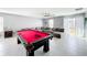 Bright living area with a pool table and large sofa perfect for Gathering gatherings at 744 Simone Ct, Haines City, FL 33844