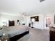 Carpeted main bedroom featuring a ceiling fan, TV, mirrors, and ample closet space at 744 Simone Ct, Haines City, FL 33844