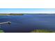 Expansive waterfront view features a dock and tranquil, shimmering waters at 744 Simone Ct, Haines City, FL 33844