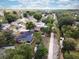 Aerial view of a home with a swimming pool in the backyard, bordered by lush landscaping at 7714 Lady Frances Way, Orlando, FL 32807